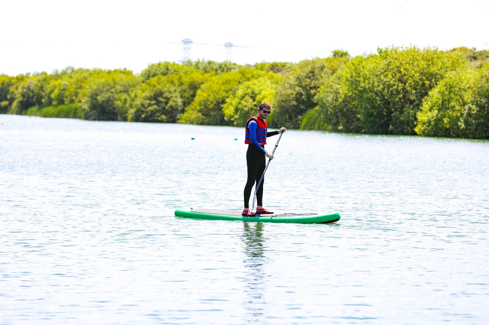 Paddle boarder on a calm lake